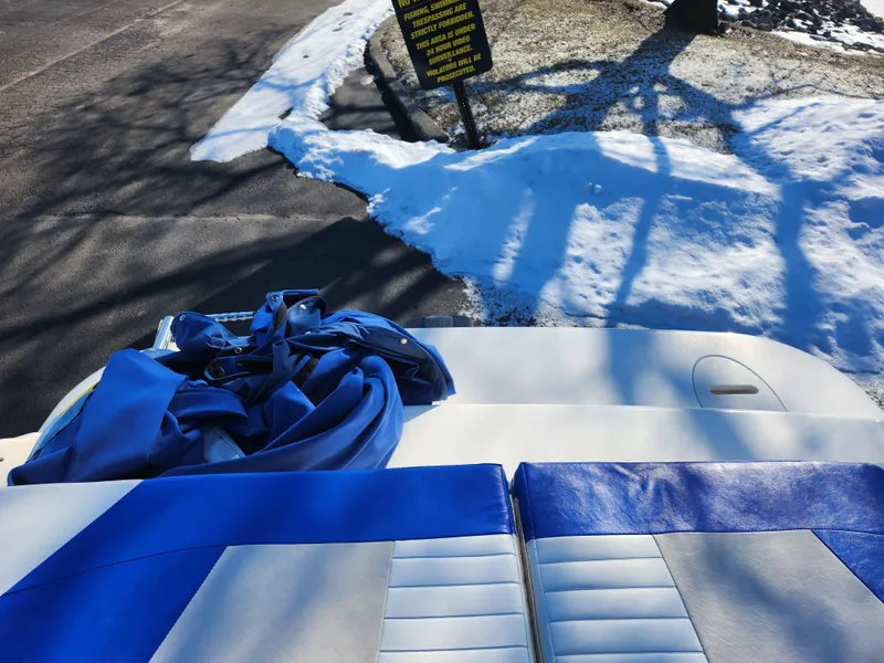 Slide: The Image of 2008 Glastron GT 205 Ski & Fish boat interior with blue and white seats, snowy background. - 27