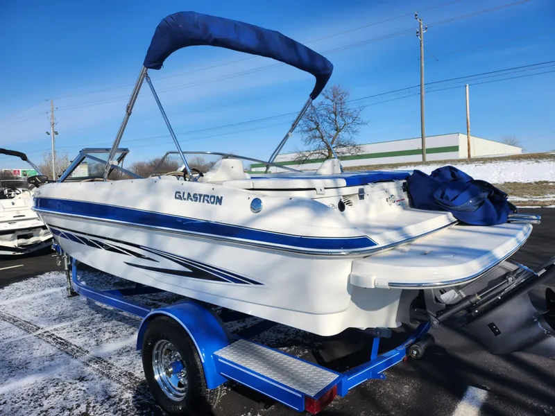 Slide: The Image of 2008 Glastron GT 205 Ski & Fish boat on trailer, blue and white design. - 3