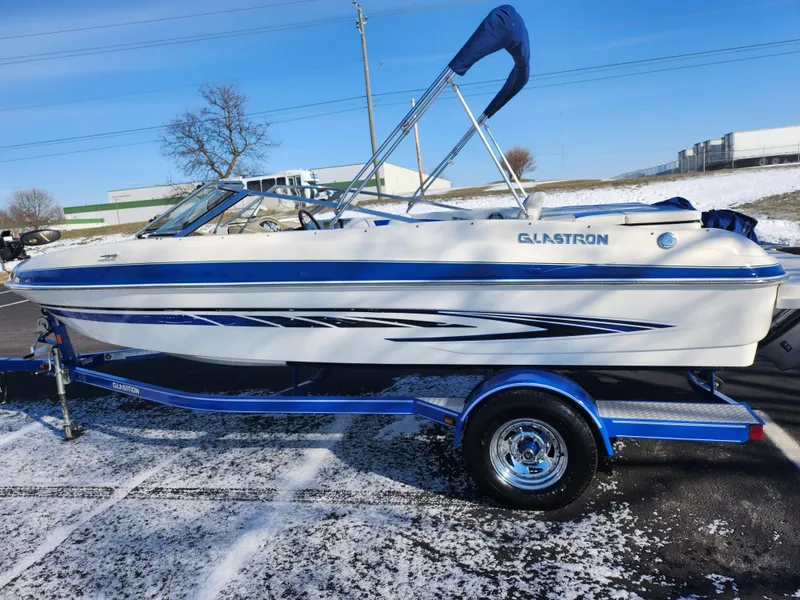 Slide: The Image of 2008 Glastron GT 205 Ski & Fish boat on trailer, blue and white design. - 4