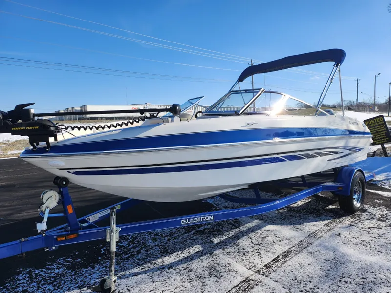 Slide: The Image of 2008 Glastron GT 205 Ski & Fish boat on trailer, blue and white design. - 6