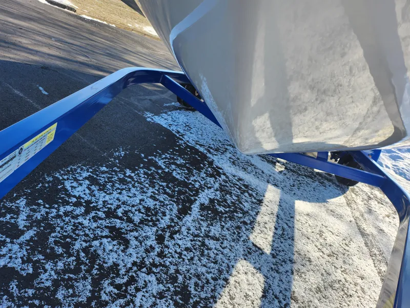 Slide: The Image of 2008 Glastron GT 205 Ski & Fish boat on a blue trailer, snowy ground. - 8