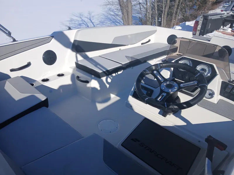 Slide: The Image of 2025 Starcraft SV 16 OB boat interior with steering wheel and seating. - 4