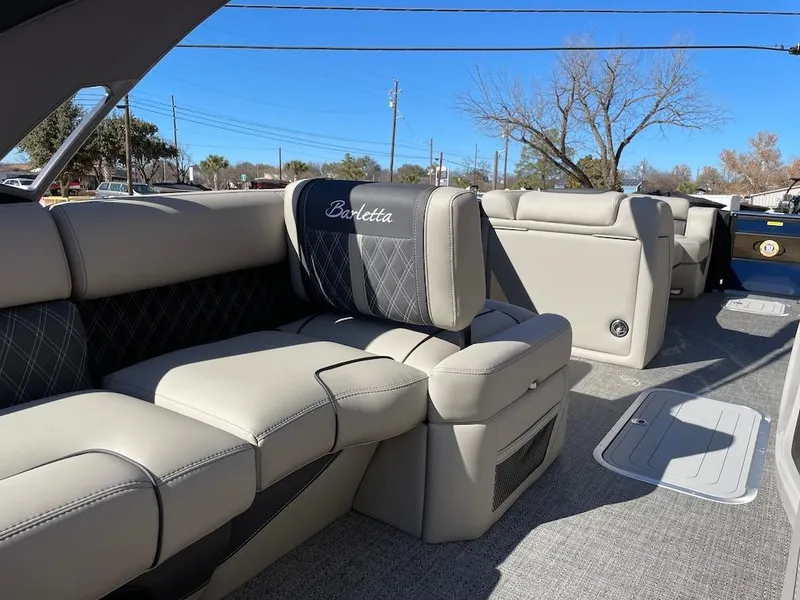 Slide: The Image of 2025 Barletta Lusso 25QSS boat interior with luxurious beige seating and elegant design. - 14