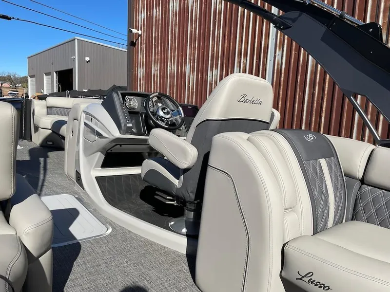 Slide: The Image of 2025 Barletta Lusso 25QSS boat interior with luxurious seating and modern dashboard. - 15