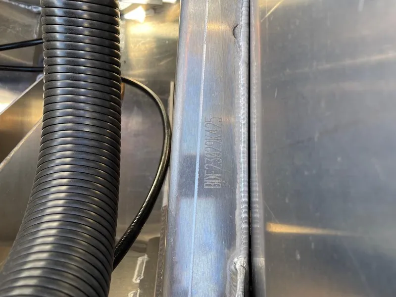 Slide: The Image of Close-up of Barletta Lusso 25QSS 2025 boat component with wiring and metal surface. - 19