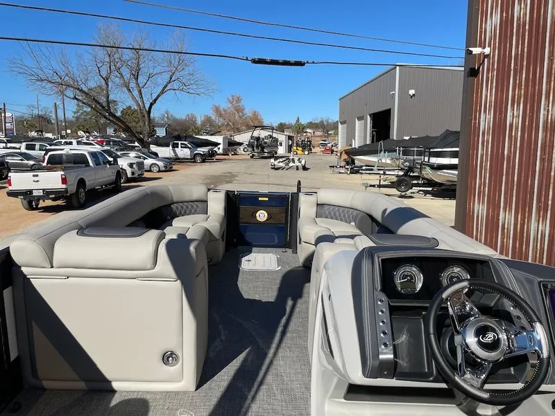 Slide: The Image of 2025 Barletta Lusso 25QSS pontoon boat interior with luxurious seating and modern dashboard. - 5