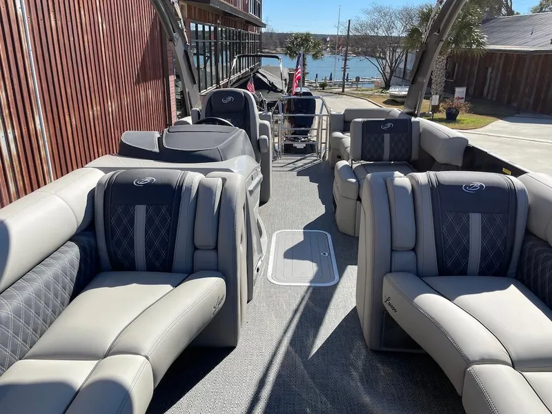 Slide: The Image of 2025 Barletta Lusso 25QSS pontoon boat with luxurious seating and lake view. - 9