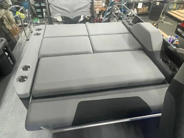 Slide: The Image of 2025 South Bay 500 boat interior with gray cushioned seating and cup holders. - 11