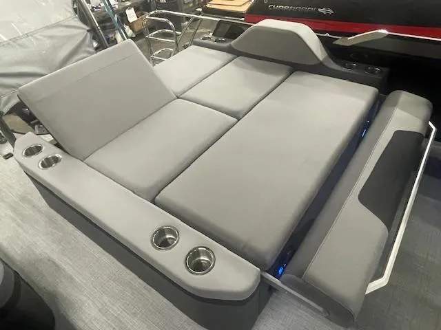 Slide: The Image of Luxurious South Bay 500 boat seating, 2025 model, featuring gray cushions and integrated cup holders. - 12
