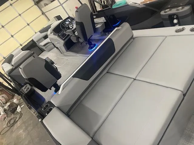 Slide: The Image of 2025 South Bay 500 boat interior with modern seating and blue LED lighting. - 16