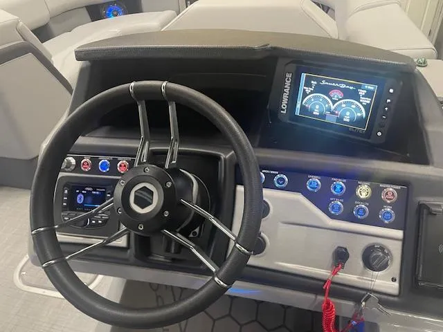 Slide: The Image of Steering console of 2025 South Bay 500 boat with digital display and controls. - 17