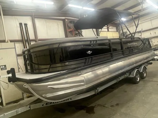 Slide: The Image of 2025 South Bay 500 pontoon boat in a warehouse on a trailer. - 4