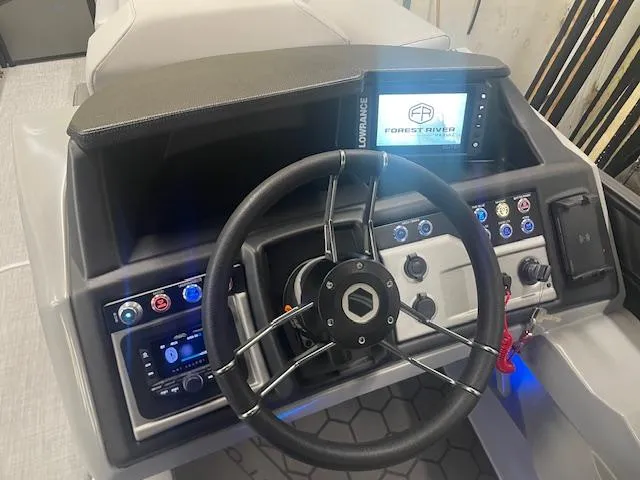Slide: The Image of Steering console of 2025 South Bay 500 boat with modern controls and display. - 6