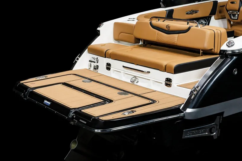 Slide: The Image of 2025 Chaparral 28 Surf boat with tan seating and sleek design. - 14