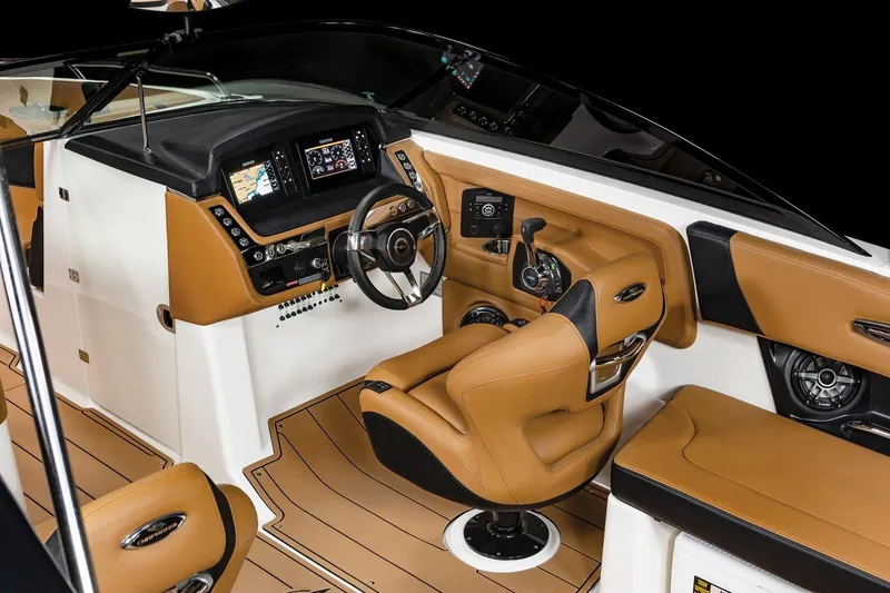 Slide: The Image of 2025 Chaparral 28 Surf boat interior with modern dashboard and tan seating. - 4