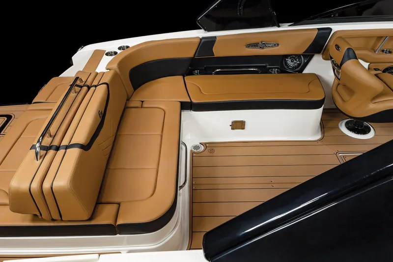 Slide: The Image of 2025 Chaparral 28 Surf boat interior with tan leather seating and wood flooring. - 8