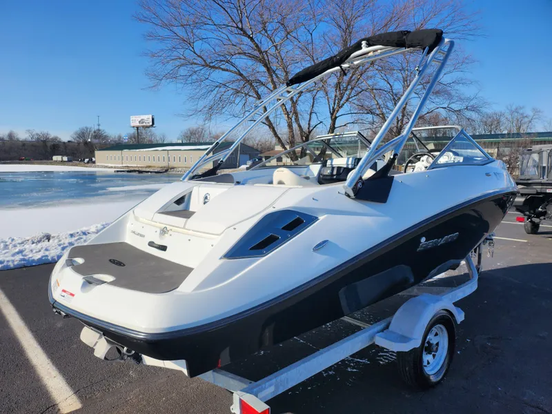 Slide: The Image of 2012 Sea-Doo 180 Challenger SE boat on trailer, parked near snowy landscape. - 1