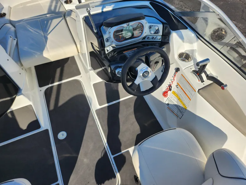 Slide: The Image of 2012 Sea-Doo 180 Challenger SE boat interior with steering wheel and dashboard controls. - 12