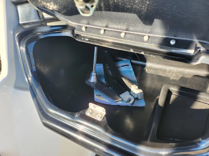 Slide: The Image of Open storage compartment of 2012 Sea-Doo 180 Challenger SE with tools inside. - 15
