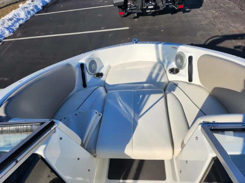 Slide: The Image of 2012 Sea-Doo 180 Challenger SE boat interior with white seating and speakers. - 16
