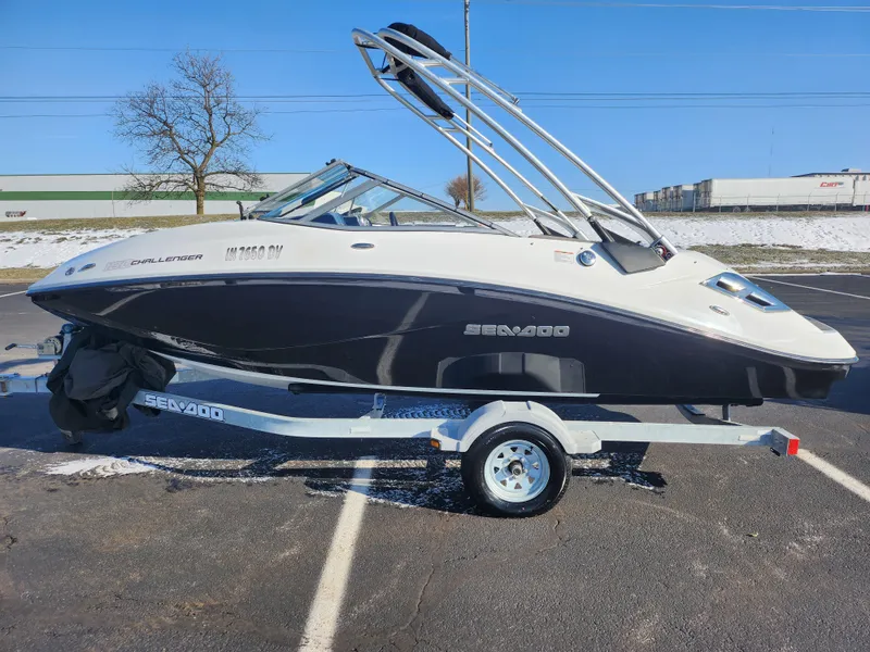 Slide: The Image of 2012 Sea-Doo 180 Challenger SE boat on trailer in parking lot. - 4