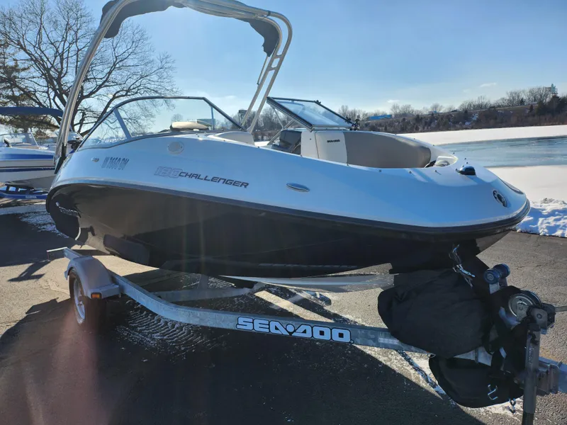 Slide: The Image of 2012 Sea-Doo 180 Challenger SE boat on trailer by a snowy riverbank. - 8