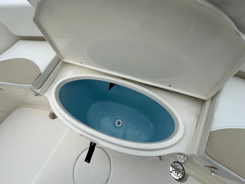 Slide: The Image of 2025 Bulls Bay 200 Center Console boat's open storage compartment. - 10