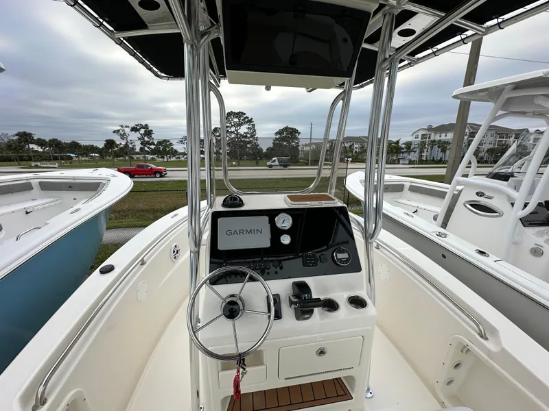 Slide: The Image of 2025 Bulls Bay 200 Center Console boat with Garmin navigation, steering wheel, and control panel. - 4