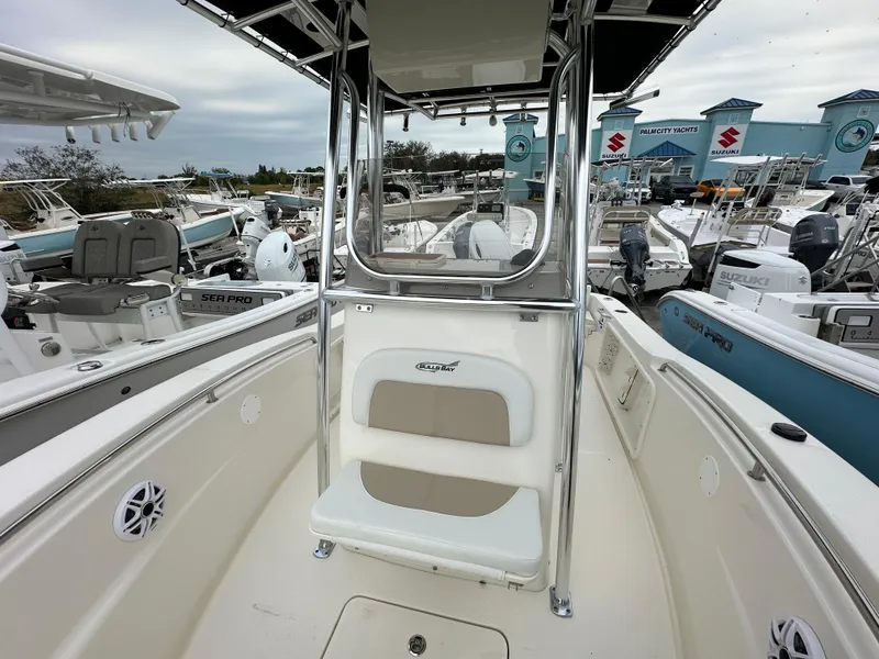 Slide: The Image of 2025 Bulls Bay 200 Center Console boat at a marina, surrounded by other vessels. - 6