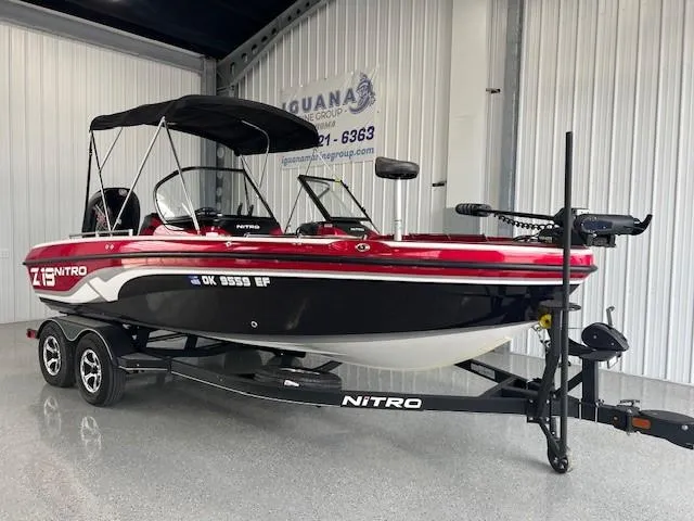 Slide: The Image of 2020 Nitro ZV19 Pro boat in showroom, red and black design, on trailer. - 4
