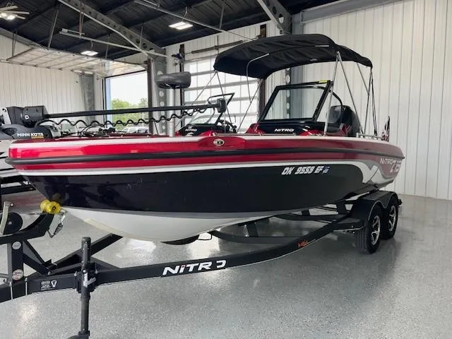 Slide: The Image of 2020 Nitro ZV19 Pro boat in a garage, featuring a sleek red and black design. - 5