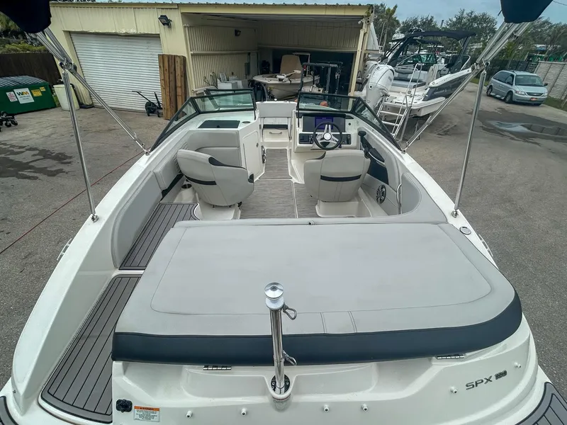 Slide: The Image of 2023 Sea Ray SPX 190 OB boat interior with seating and steering wheel. - 3