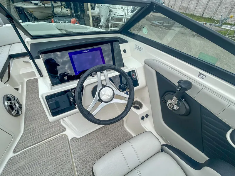 Slide: The Image of 2023 Sea Ray SPX 190 OB boat cockpit with modern steering and control panel. - 4