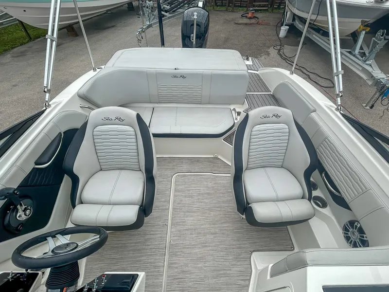 Slide: The Image of 2023 Sea Ray SPX 190 OB boat interior with seating and steering wheel. - 7
