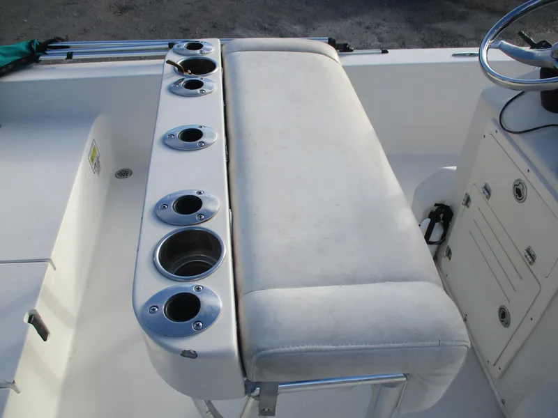 Slide: The Image of 2011 Pathfinder 2200 XL boat interior with cushioned seating and multiple cup holders. - 10