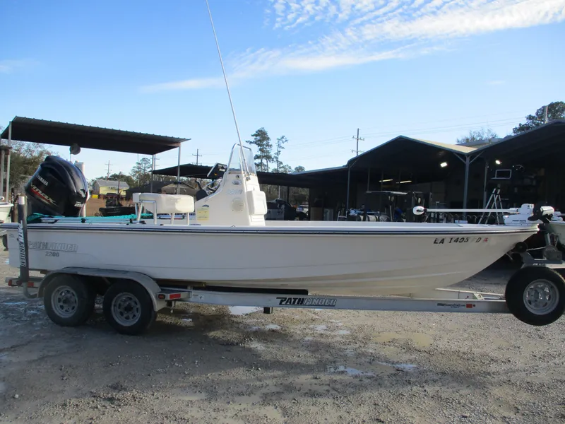 Slide: The Image of 2011 Pathfinder 2200 XL boat on trailer, parked outdoors. - 2