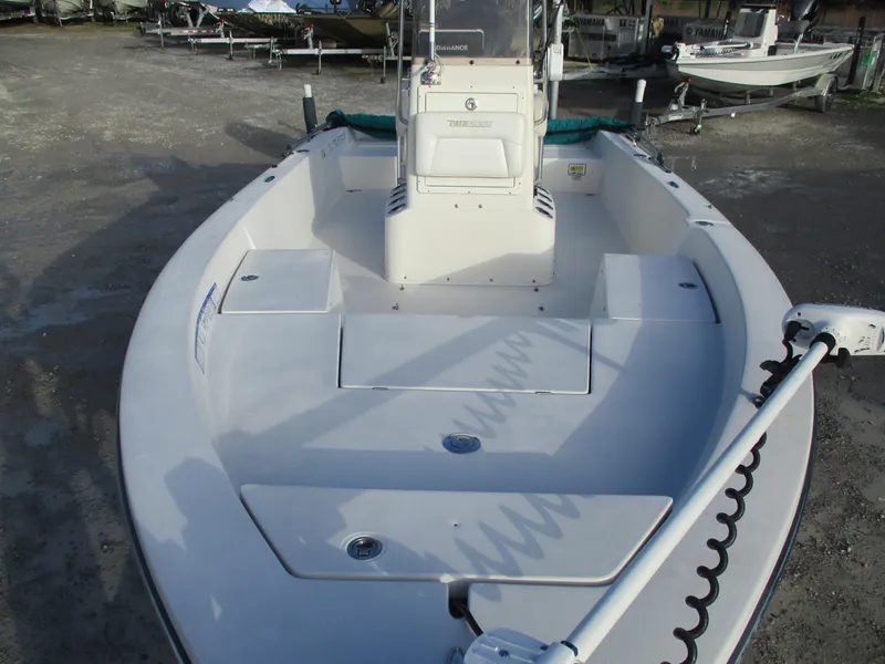 Slide: The Image of 2011 Pathfinder 2200 XL boat, white deck, center console, parked on land. - 7