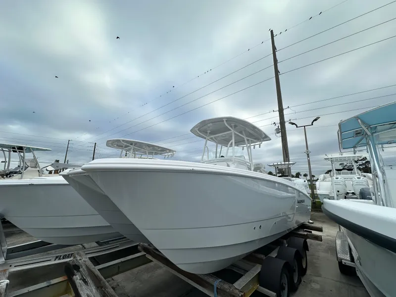 The Image of 2025 Twin Vee 240 GFX CC boat on trailer under cloudy sky. - 1