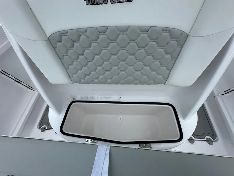 Slide: The Image of 2025 Twin Vee 240 GFX CC boat interior with hexagonal-patterned upholstery and storage compartment. - 10
