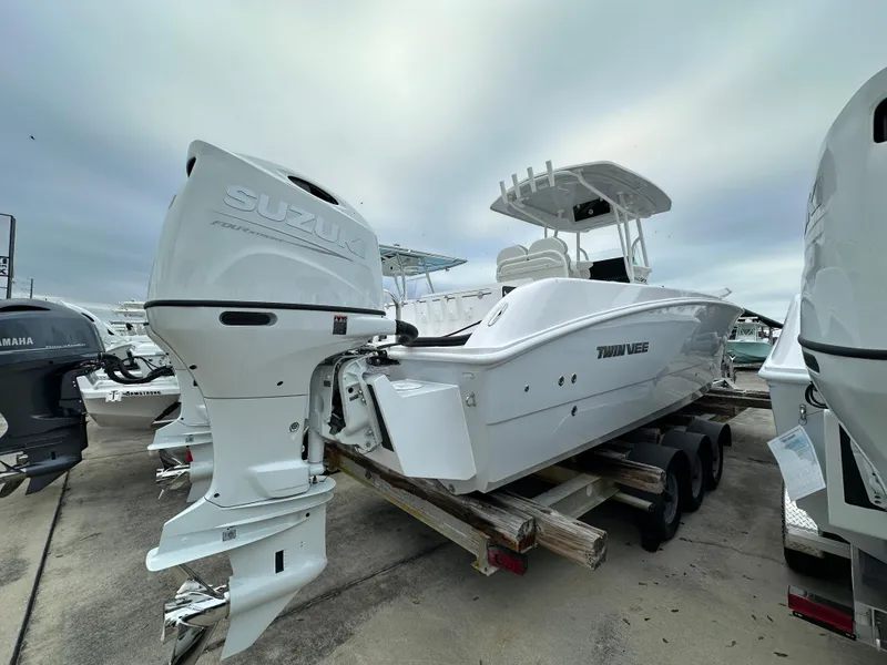 Slide: The Image of 2025 Twin Vee 240 GFX CC boat with Suzuki outboard engine on a trailer. - 3