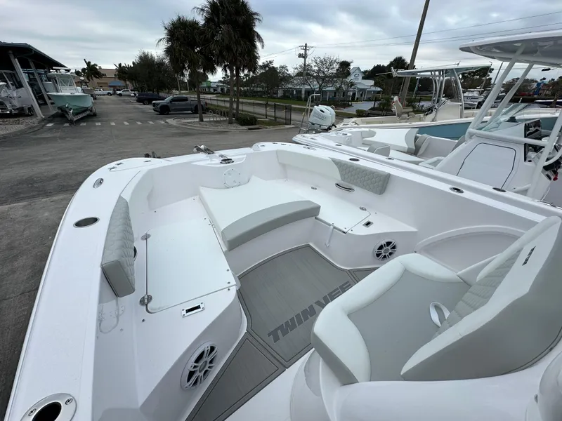 Slide: The Image of 2025 Twin Vee 240 GFX CC boat interior with white seating and modern design. - 6