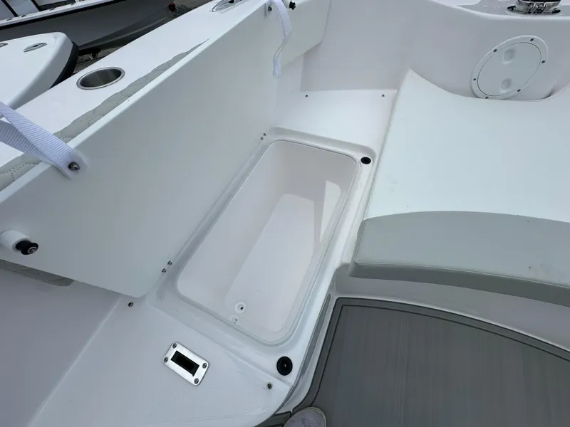Slide: The Image of 2025 Twin Vee 240 GFX CC boat interior with storage compartment and seating area. - 7