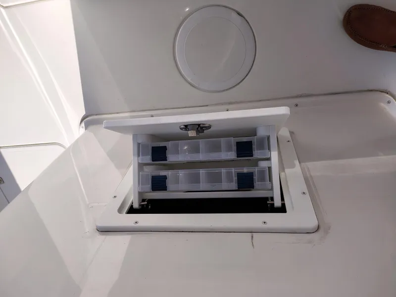 Slide: The Image of 2024 Parker 2900 Center Console boat storage compartment with open lid. - 12
