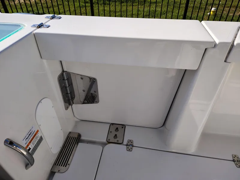Slide: The Image of 2024 Parker 2900 Center Console boat interior detail with white finish and metal hinges. - 15
