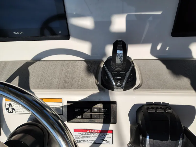 Slide: The Image of 2024 Parker 2900 Center Console boat dashboard with steering wheel and controls. - 17