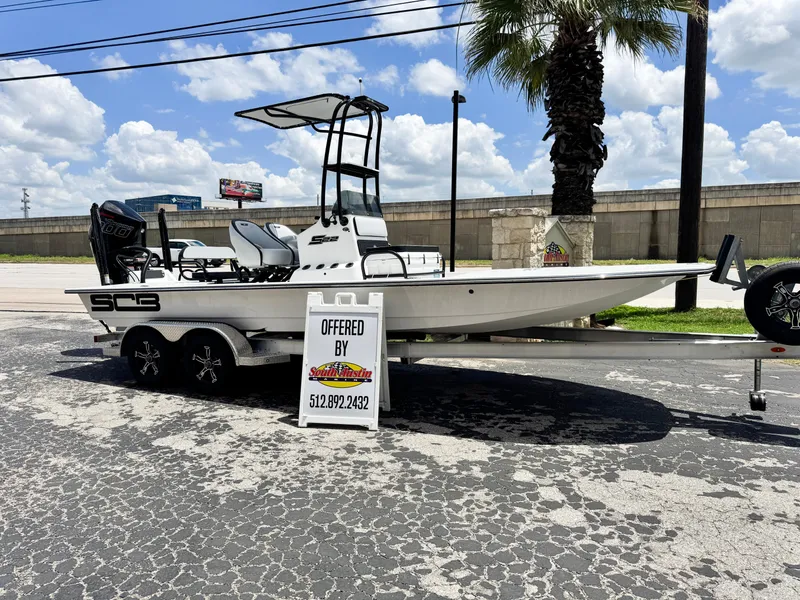 The Image of 2025 SCB S22 boat on trailer, displayed outdoors with sale sign. - 0