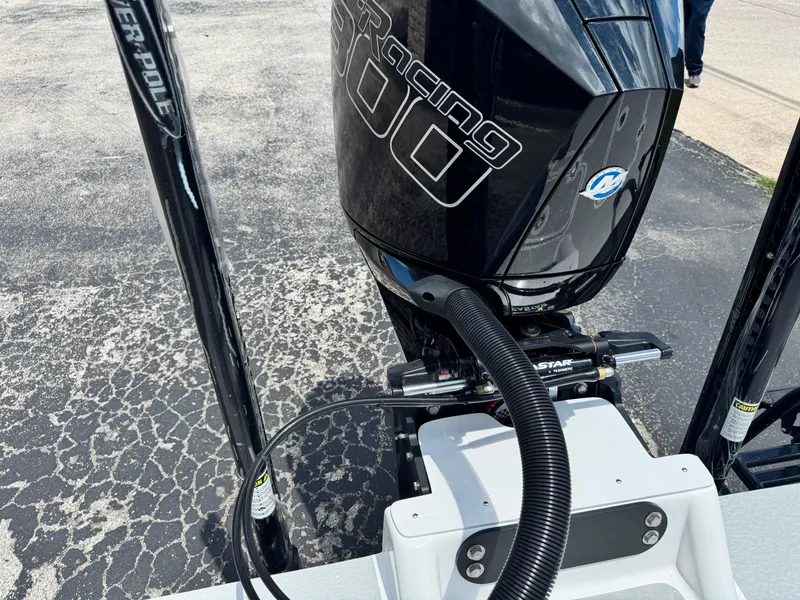 Slide: The Image of 2025 SCB S22 boat engine with Power-Pole anchors on textured pavement. - 10