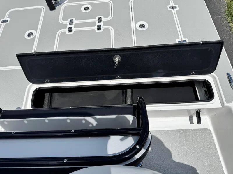 Slide: The Image of 2025 SCB S22 boat deck with open storage compartment and sleek design. - 13