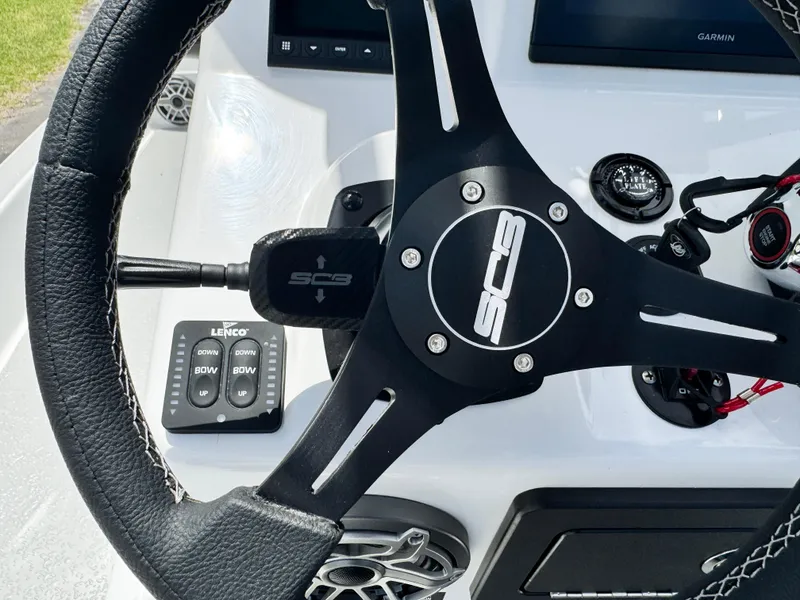 Slide: The Image of Steering wheel of 2025 SCB S22 boat with control panel and Lenco switches. - 18