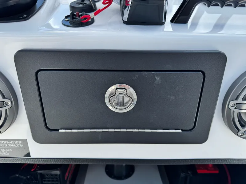 Slide: The Image of 2025 SCB S22 boat dashboard with a secure storage compartment and speakers. - 20